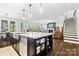Open-concept kitchen with a large island, stainless steel appliances, and a view into the living area at 1255 Fishing Creek Rd, Clover, SC 29710