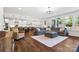 Open-concept living room with hardwood floors, large sectional sofa, and well-lit kitchen at 1255 Fishing Creek Rd, Clover, SC 29710