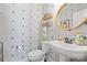 Stylish powder room featuring a pedestal sink, round mirror and attractive patterned walls at 1255 Fishing Creek Rd, Clover, SC 29710