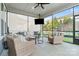 Relaxing screened porch with wicker furniture, ceiling fan, and views of the backyard at 1255 Fishing Creek Rd, Clover, SC 29710