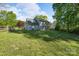 Beautifully landscaped backyard with mature trees and a wooden fence at 12604 Cardinal Point Rd, Charlotte, NC 28269