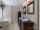 Bathroom features double sink vanity, tile floors and soaking tub at 12604 Cardinal Point Rd, Charlotte, NC 28269