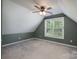 Carpeted bedroom with natural light and ceiling fan at 12604 Cardinal Point Rd, Charlotte, NC 28269