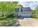 Charming two-story home features a spacious driveway, an attached garage, and beautifully landscaped front yard at 12604 Cardinal Point Rd, Charlotte, NC 28269
