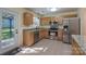 Bright kitchen features stainless steel appliances, tile floors, and granite countertops at 12604 Cardinal Point Rd, Charlotte, NC 28269