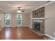 Living room with hardwood flooring and a stone fireplace at 12604 Cardinal Point Rd, Charlotte, NC 28269