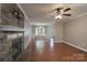 Living room with hardwood flooring and a stone fireplace at 12604 Cardinal Point Rd, Charlotte, NC 28269