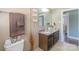 Bathroom featuring a large vanity with granite countertop, neutral wall color, and decorative elements at 12842 Plaza Road Ext, Charlotte, NC 28215