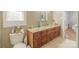 Bathroom with wood cabinets, a granite countertop, and wood-look vinyl flooring at 12842 Plaza Road Ext, Charlotte, NC 28215