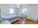 Bright bedroom with hardwood floors, white trim, ceiling fan, and ample natural light at 12842 Plaza Road Ext, Charlotte, NC 28215