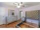 Cozy bedroom showcasing hardwood floors, a silver dresser, and a tufted headboard at 12842 Plaza Road Ext, Charlotte, NC 28215