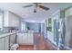 Spacious kitchen featuring white cabinetry, stainless steel appliances, tile backsplash, and hardwood floors at 12842 Plaza Road Ext, Charlotte, NC 28215