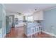 Bright kitchen featuring white cabinets, stainless steel appliances, and hardwood flooring, perfect for cooking and entertaining at 12842 Plaza Road Ext, Charlotte, NC 28215