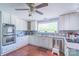 Bright kitchen featuring white cabinets, stainless steel appliances, and hardwood flooring for a modern feel at 12842 Plaza Road Ext, Charlotte, NC 28215