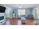 Cozy living room featuring hardwood floors, a decorative fireplace, and plenty of light at 12842 Plaza Road Ext, Charlotte, NC 28215