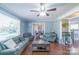 Inviting living room with large windows, comfortable seating and a view into the dining area at 12842 Plaza Road Ext, Charlotte, NC 28215