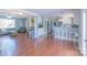 Open-concept living space with hardwood floors connecting the living room and kitchen at 12842 Plaza Road Ext, Charlotte, NC 28215