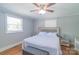 Comfortable main bedroom with two windows, a ceiling fan, and a closet at 12842 Plaza Road Ext, Charlotte, NC 28215