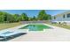 Backyard swimming pool surrounded by a concrete deck, green grass, and an outdoor chaise lounge at 12842 Plaza Road Ext, Charlotte, NC 28215