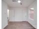 A spacious bedroom with wood-look flooring, a modern ceiling fan, and multiple windows for natural light at 129 Wilson St, Chester, SC 29706