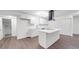 Bright kitchen featuring an island, modern lighting, stainless steel appliances, and crisp white cabinetry at 129 Wilson St, Chester, SC 29706