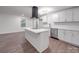 A modern kitchen features an island, stainless steel appliances, and crisp white cabinetry at 129 Wilson St, Chester, SC 29706