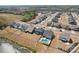 Aerial view of homes in a neighborhood with a pond and community pool at 13102 Petrel Pl, Charlotte, NC 28278