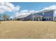 Expansive backyard featuring a well-maintained lawn and a covered patio, ideal for outdoor activities at 13102 Petrel Pl, Charlotte, NC 28278