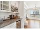 A stylish bar area featuring a wine rack, granite countertop, and a beverage refrigerator at 13102 Petrel Pl, Charlotte, NC 28278