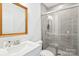 Modern bathroom featuring a sleek glass-enclosed shower, white vanity, and a large, illuminated mirror at 13102 Petrel Pl, Charlotte, NC 28278