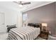 Cozy bedroom featuring a ceiling fan, neutral tones, stylish bedding, and a window for natural light at 13102 Petrel Pl, Charlotte, NC 28278