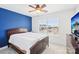 Charming bedroom featuring a ceiling fan, flat screen television, a bright window and dark wood furniture at 13102 Petrel Pl, Charlotte, NC 28278