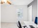 Office room with ceiling fan, white walls and trim, small window and chair at a white desk at 13102 Petrel Pl, Charlotte, NC 28278