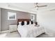 Comfortable bedroom featuring a ceiling fan, tray ceiling, and neutral color palette at 13102 Petrel Pl, Charlotte, NC 28278