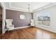 Bright dining room featuring hardwood floors, elegant lighting, and large window at 13102 Petrel Pl, Charlotte, NC 28278