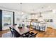 Modern, eat-in kitchen featuring an island with seating and bright lighting. Hardwood flooring throughout at 13102 Petrel Pl, Charlotte, NC 28278