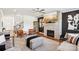 Stylish living room with a brick fireplace, modern decor, and hardwood floors at 13102 Petrel Pl, Charlotte, NC 28278