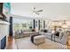 Bright, expansive living room featuring large windows, hardwood floors and contemporary furnishings and decor at 13102 Petrel Pl, Charlotte, NC 28278