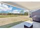 Covered patio overlooking a spacious backyard and serene pond, perfect for outdoor relaxation and entertaining at 13102 Petrel Pl, Charlotte, NC 28278