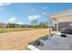 Covered patio overlooking a spacious backyard and serene pond, a perfect spot for relaxation at 13102 Petrel Pl, Charlotte, NC 28278