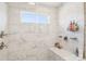 A tile shower with a built-in bench, multiple shower heads, and tiled walls at 13102 Petrel Pl, Charlotte, NC 28278
