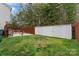Fenced backyard with green grass and a storage shed offers lots of room to enjoy the outdoors at 140 Camforth Dr, Mooresville, NC 28117