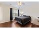 Comfortable bedroom with vaulted ceiling, large window, and stylish dark curtains at 140 Camforth Dr, Mooresville, NC 28117