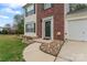 Beautiful walkway and entry to the house, with stone features, flower beds, and green front door at 140 Camforth Dr, Mooresville, NC 28117