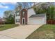 Charming two-story home with a well-maintained lawn, a brick facade, and an attached garage at 140 Camforth Dr, Mooresville, NC 28117
