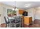 Eat-in kitchen boasts modern appliances, ample cabinet space, and a sliding glass door for outdoor access at 140 Camforth Dr, Mooresville, NC 28117