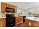 Efficient kitchen with light wood cabinets, stainless steel appliances, and a view to the breakfast nook at 140 Camforth Dr, Mooresville, NC 28117