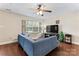 Cozy living room with a large window, comfortable seating, a ceiling fan, and wood-look flooring at 140 Camforth Dr, Mooresville, NC 28117