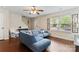 Bright living room with a blue sectional sofa, a large window, modern decor, and hardwood floors at 140 Camforth Dr, Mooresville, NC 28117