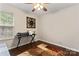 Bright office space with hardwood floors, large window, and a comfortable work environment at 140 Camforth Dr, Mooresville, NC 28117